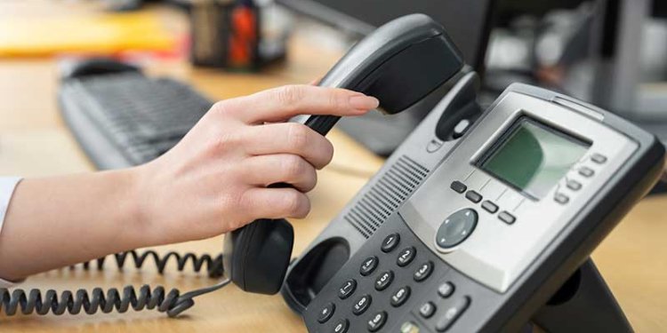 person taking phone off base