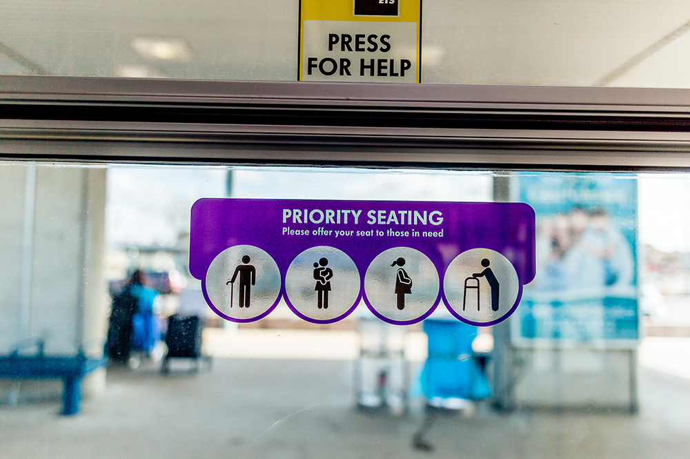 Photo of priority seating sticker on window on an LRT car