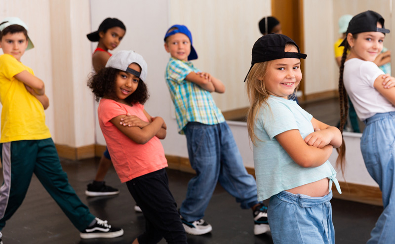 A group of kids dancing in a hip hop style.
