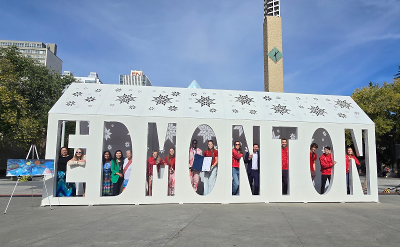 Group of people standing inside Edmonton sign